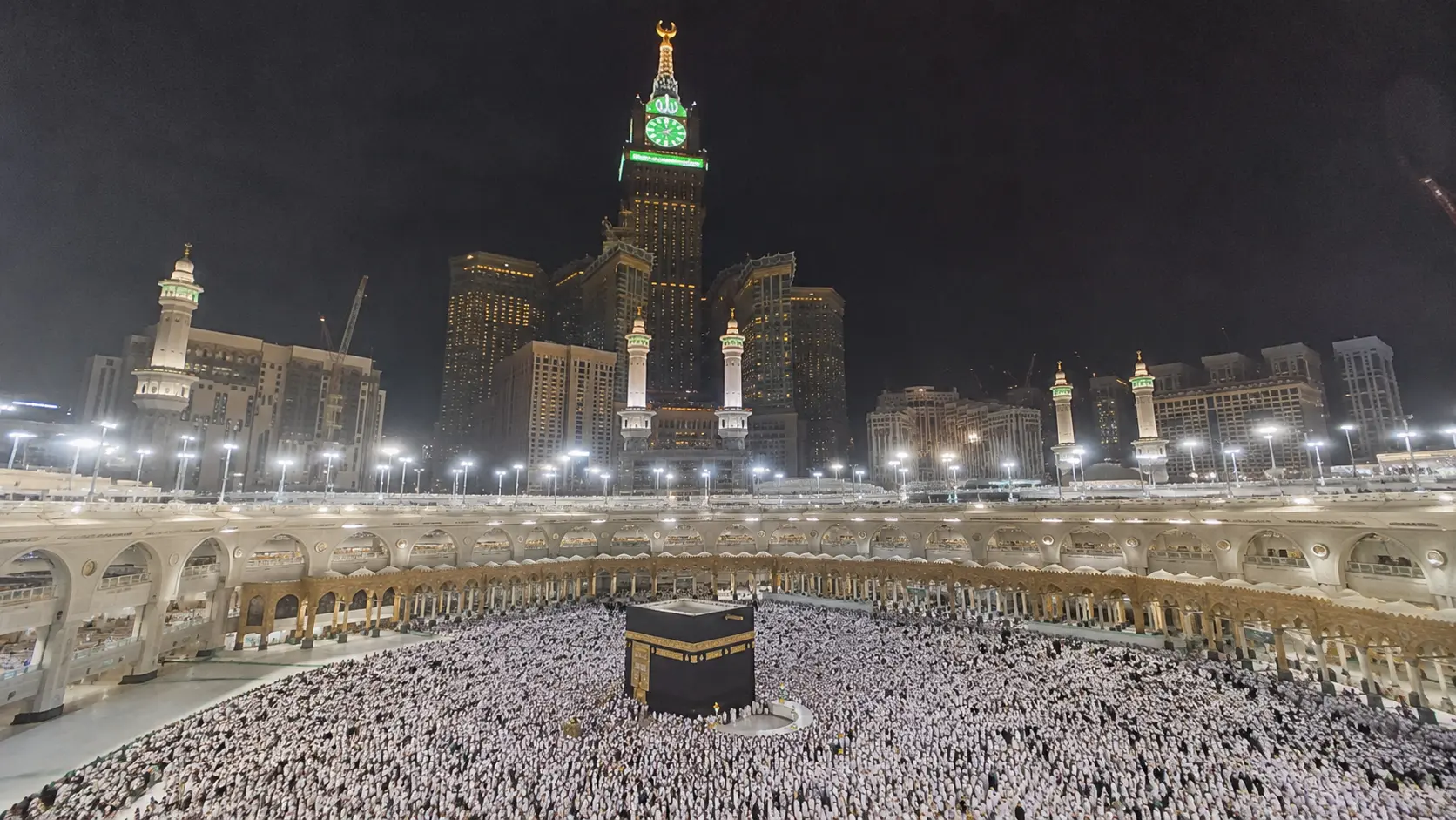 Holy Kaaba inside Masjid al-Haram in Makkah at night during Umrah pilgrimage.